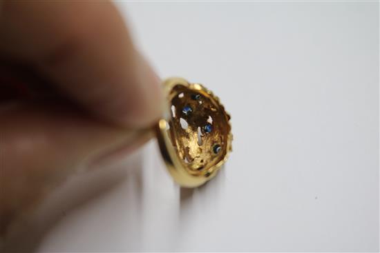 A 1960s 18ct gold and sapphire set pierced nugget ring, size M.